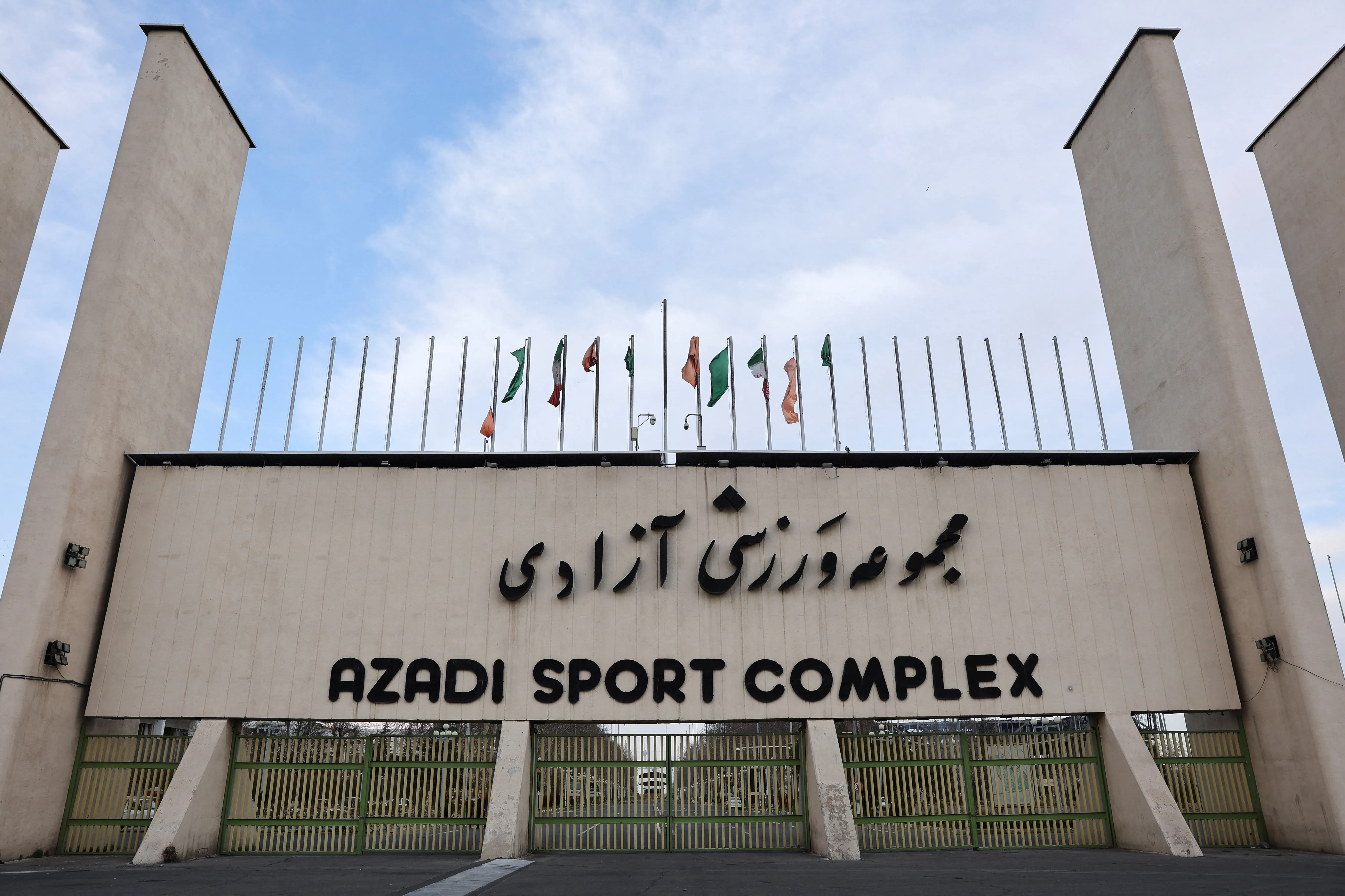 Azadi Stadium — heavy smoke rising from surrounding area, Mar 5