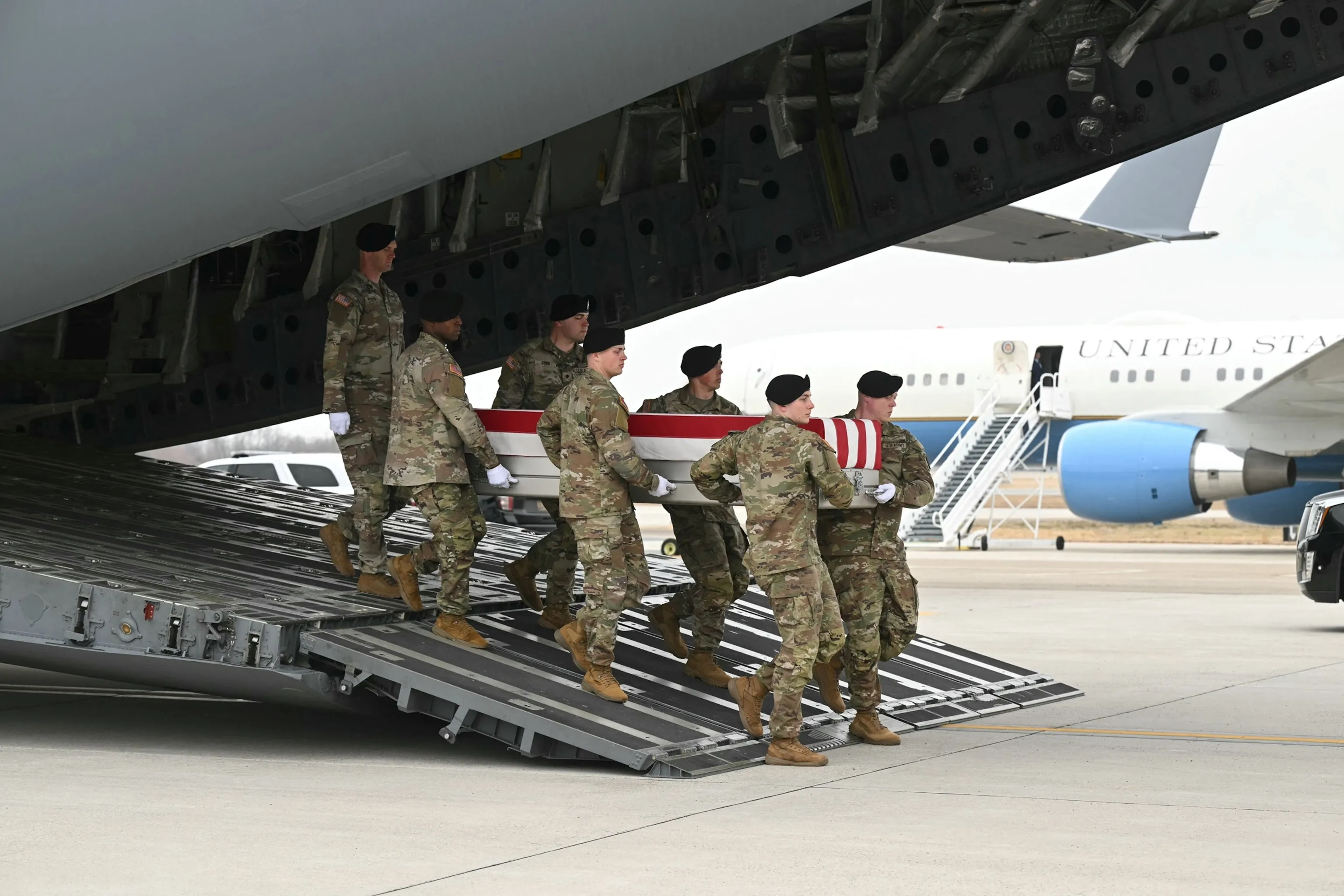 Dignified transfer at Dover AFB — flag-draped casket, Mar 7