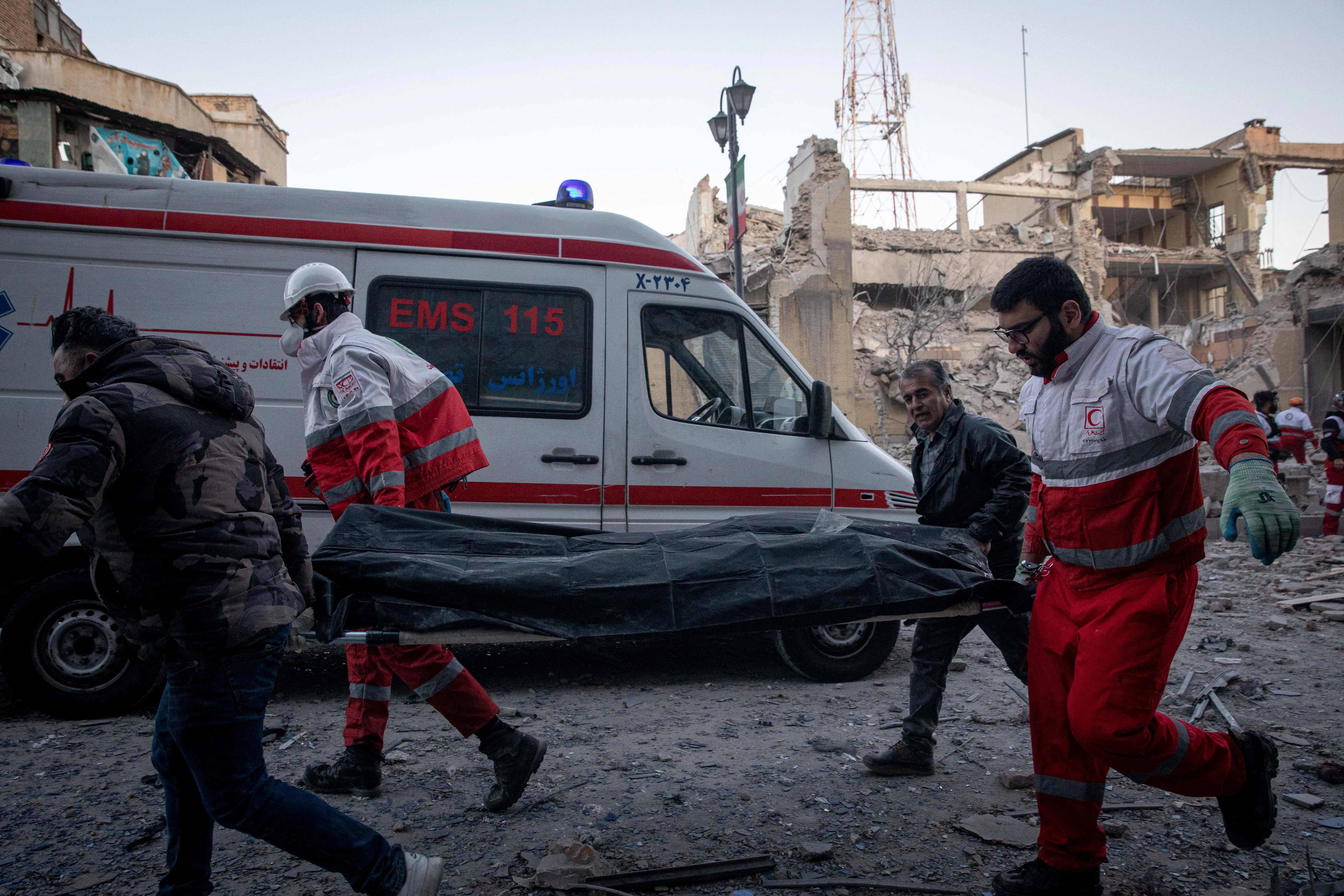 Tehran emergency response Day 5 — IRGC announces city-wide curfew as rescue teams scramble through destroyed government district